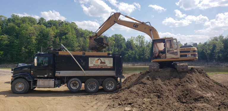 Excavator loading a dump truck for excavation material movement