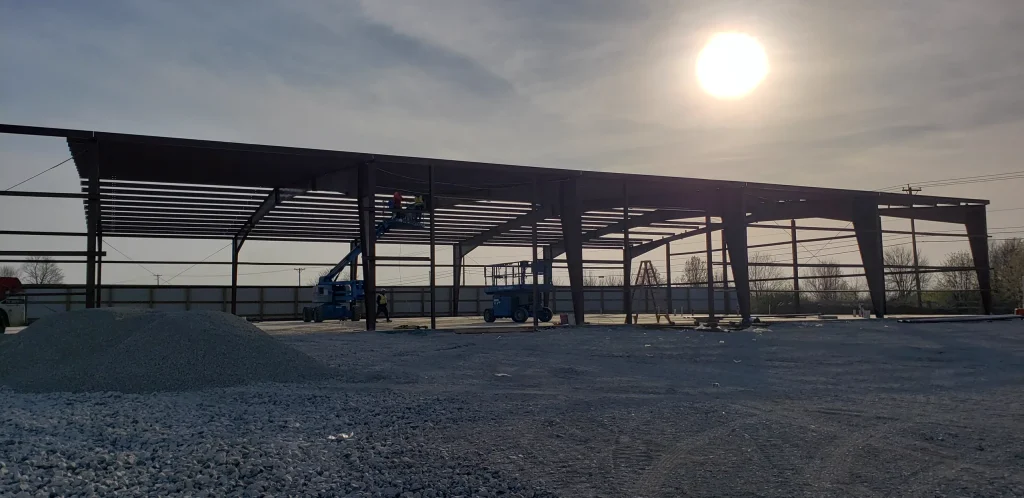 Reliable Outcomes Excavation steel frame building sunset.